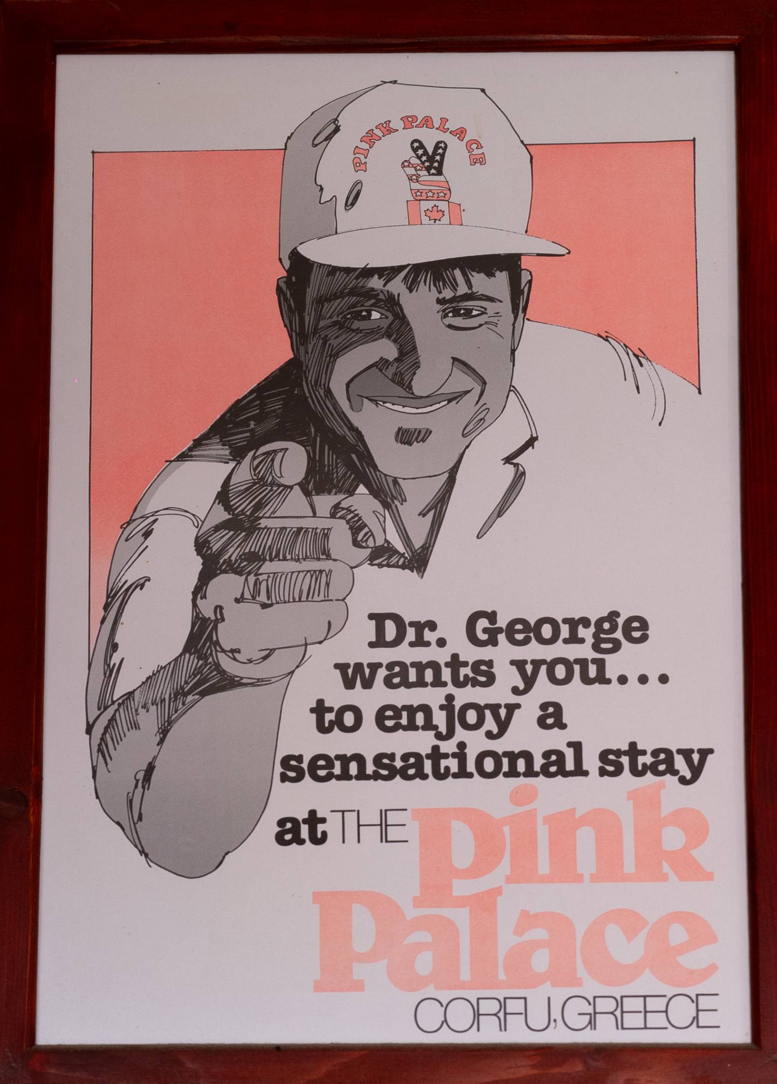 Vintage promotional poster of Dr. George — 'Dr. George wants you... to enjoy a sensational stay at THE Pink Palace · CORFU, GREECE' — framed in dark wood and hung on a property wall.